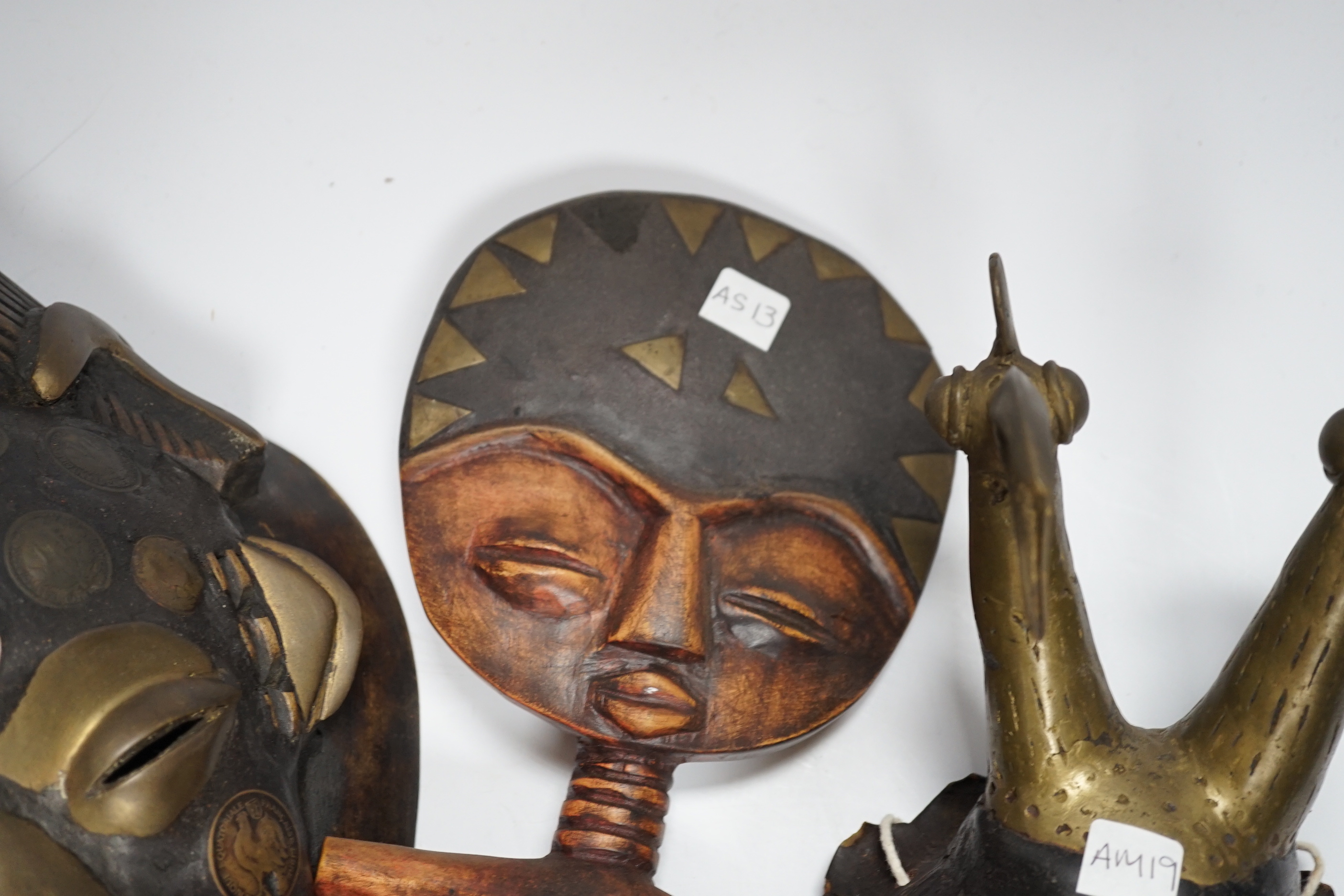 Two Lega tribal masks one made from a tortoise shell and an Ashanti fertility figure, tallest 32.5cm